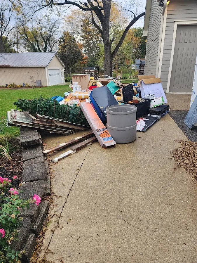 Dumpster being loaded with debris for Roofing Dumpster Rental in Milledgeville